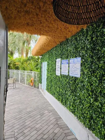 a view of a swimming pool with a table and chairs under an umbrella