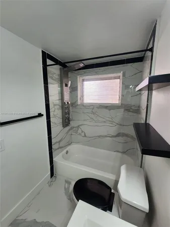 a bathroom with a toilet and a bathtub