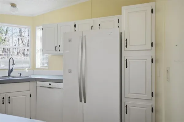 a kitchen with a refrigerator and a sink