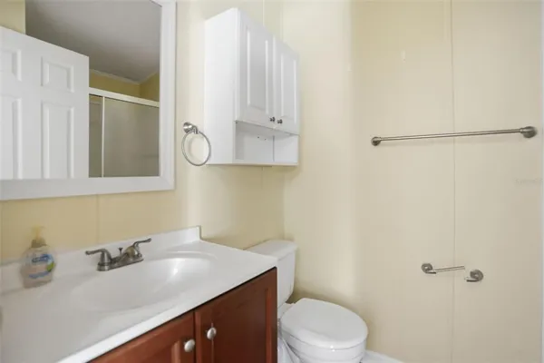 a bathroom with a sink vanity mirror and toilet