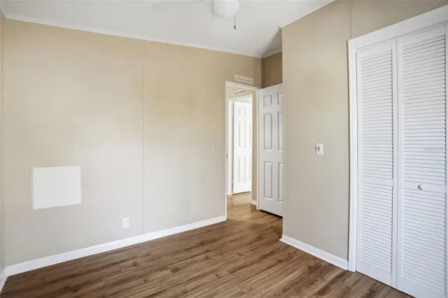 a view of an empty room with wooden floor
