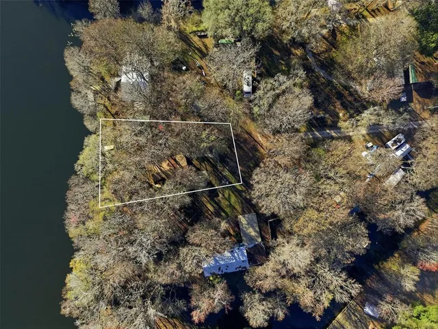 a view of a white house and a yard with swimming pool