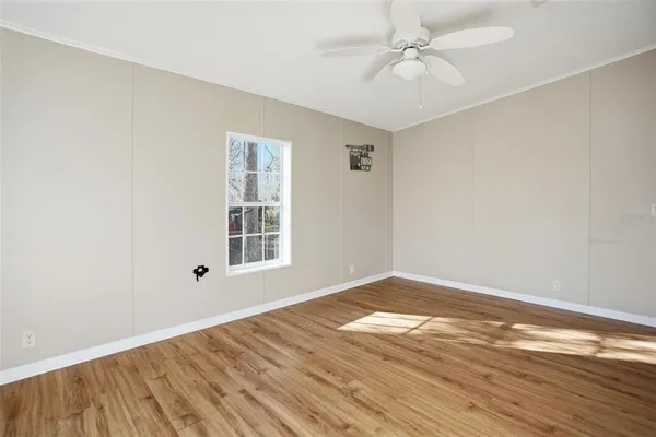 wooden floor in an empty room with a window