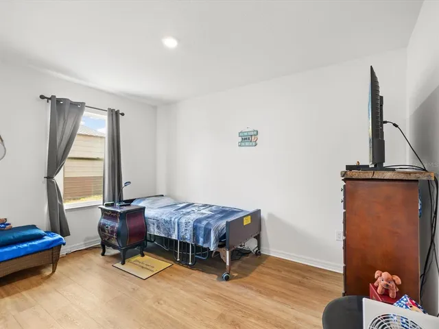 a bathroom with a granite countertop toilet sink and mirror