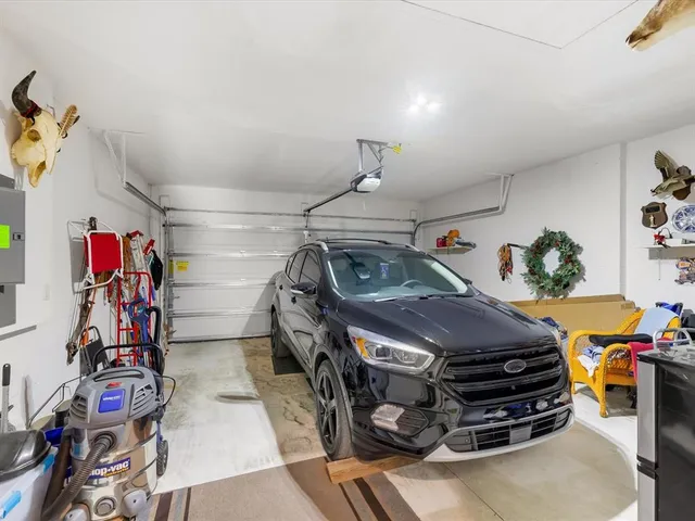 a view of a patio with a table and chairs and a barbeque