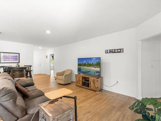 a living room with furniture and kitchen view