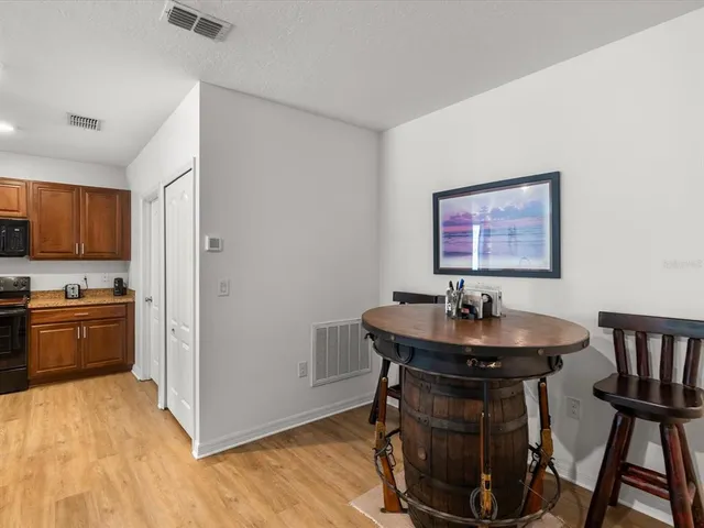 a kitchen with kitchen island a sink stove microwave and refrigerator