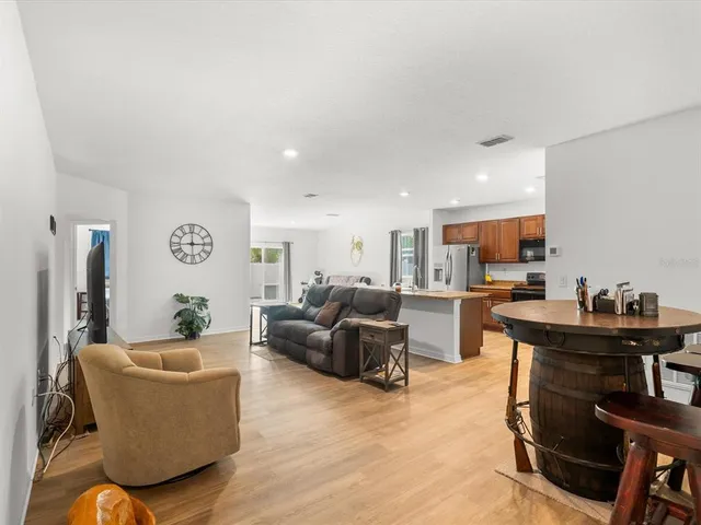 a kitchen with stainless steel appliances granite countertop a refrigerator stove top oven and sink