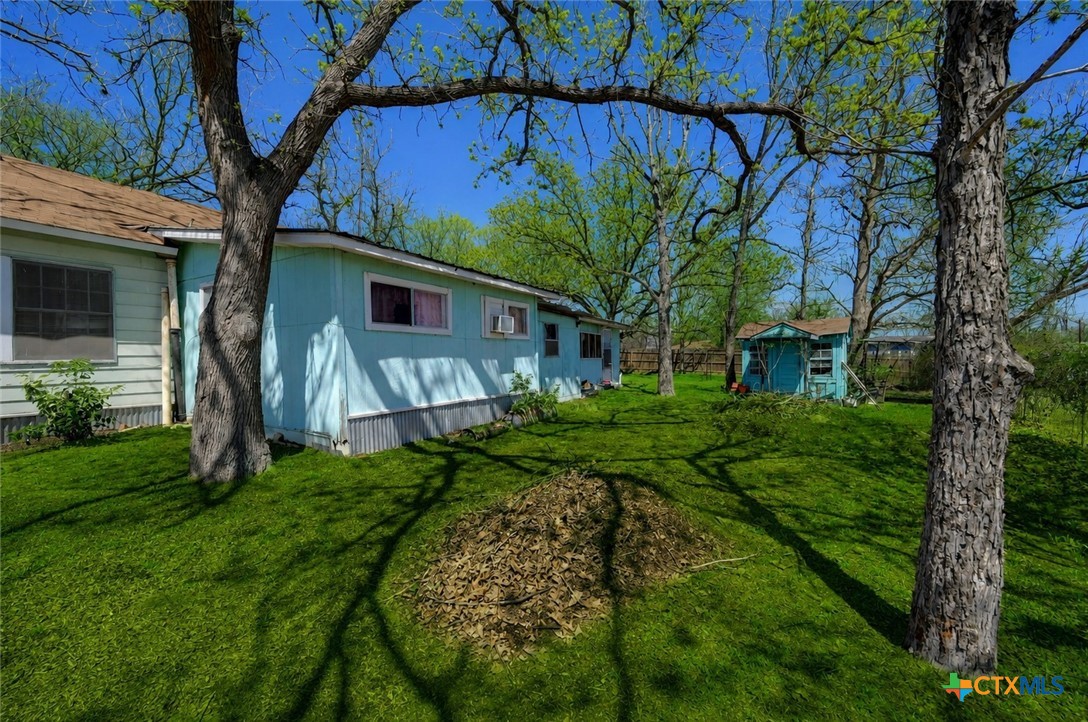 1631 East Fannin Street Luling, TX 78648 - Photo 27 of 27 a view of a house with a big yard plants and large trees