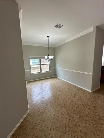 an empty room with windows and entrance