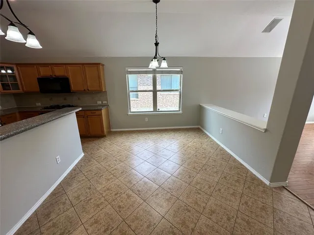 a kitchen with granite countertop cabinets stainless steel appliances and a sink