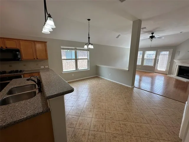 a view of a kitchen with microwave and windows