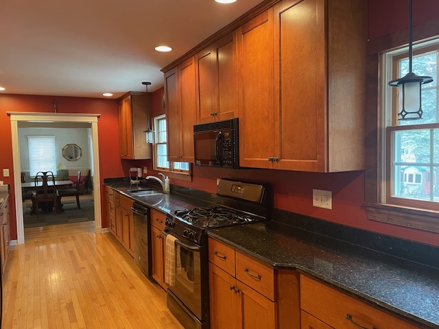 1505 West Acres Road Joliet, IL 60435 - Photo 17 of 42 a kitchen with stainless steel appliances granite countertop a stove a sink and a microwave