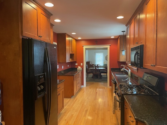 1505 West Acres Road Joliet, IL 60435 - Photo 18 of 42 a kitchen with refrigerator a stove and a wooden cabinets
