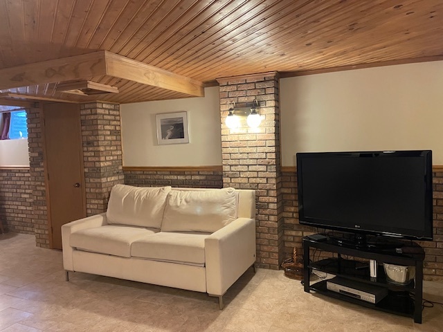 1505 West Acres Road Joliet, IL 60435 - Photo 32 of 42 a living room with furniture and a flat screen tv