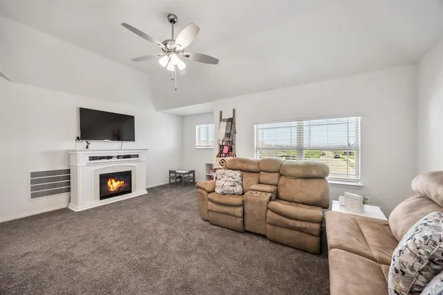 a living room with furniture a fireplace and a flat screen tv