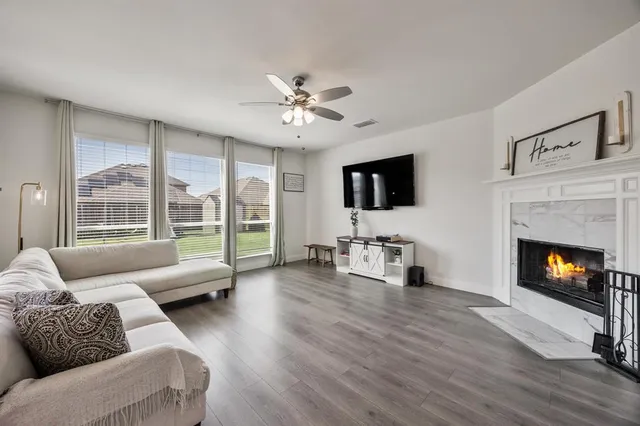 a living room with furniture flat screen tv and a fireplace