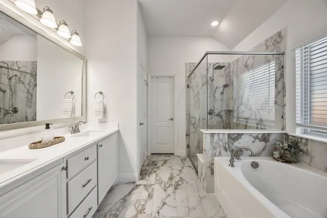 a bathroom with a tub sink and mirror