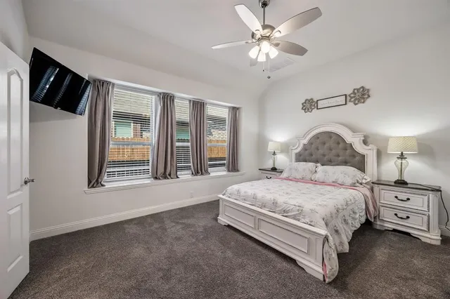 a bedroom with a large bed and a chandelier