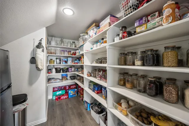 a cabinet with wine glasses on top of it