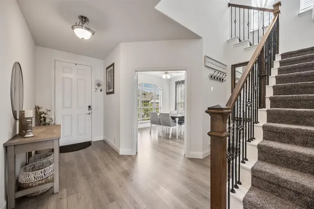 a view of entryway and hall with wooden floor