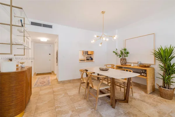 a view of a dining room and a kitchen with a table chairs