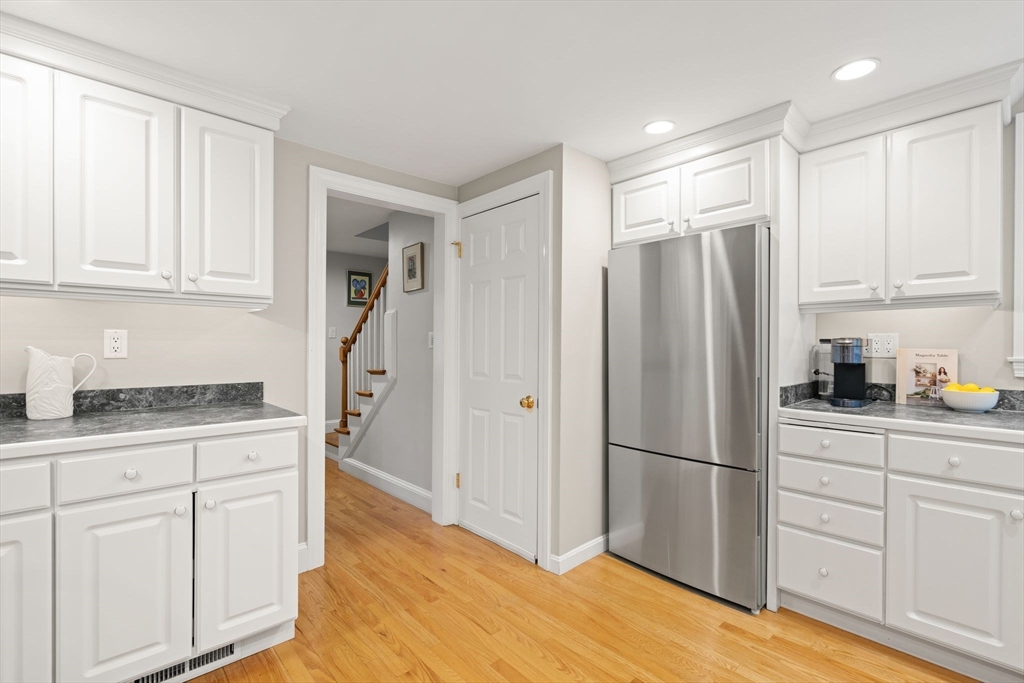 5 Brewster Road Arlington, MA 02478 - Photo 11 of 39 a kitchen with granite countertop a refrigerator and cabinets