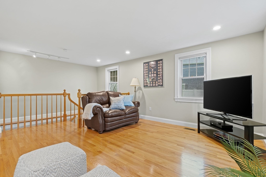 5 Brewster Road Arlington, MA 02478 - Photo 17 of 39 a living room with furniture and a flat screen tv