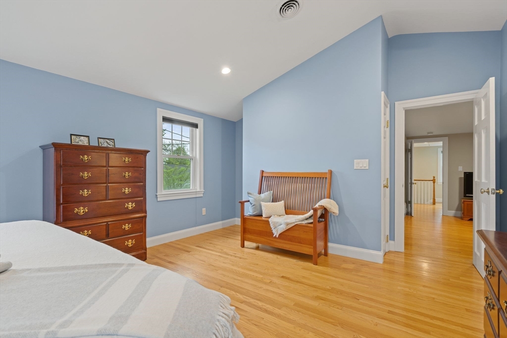 5 Brewster Road Arlington, MA 02478 - Photo 25 of 39 a bedroom with a bed and wooden floor