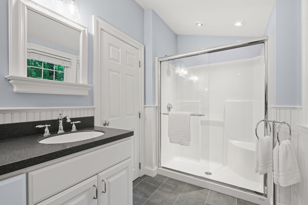 5 Brewster Road Arlington, MA 02478 - Photo 27 of 39 a bathroom with a shower sink and mirror