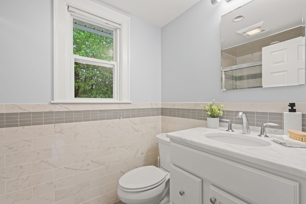 5 Brewster Road Arlington, MA 02478 - Photo 31 of 39 a bathroom with a sink a toilet and a window