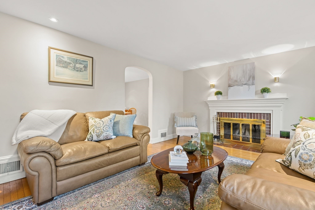 5 Brewster Road Arlington, MA 02478 - Photo 4 of 39 a living room with furniture a fireplace and a table