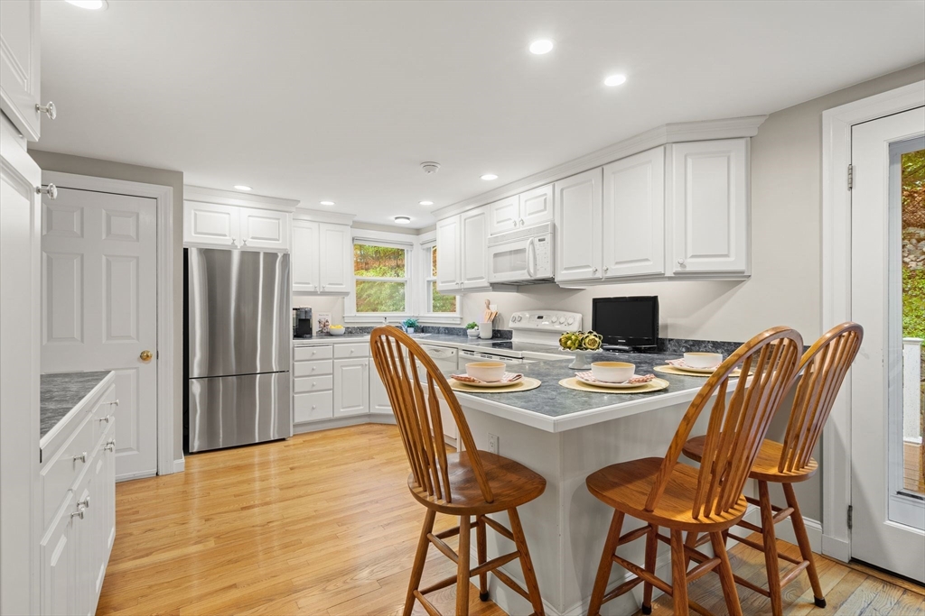 5 Brewster Road Arlington, MA 02478 - Photo 8 of 39 a kitchen with a dining table chairs and refrigerator