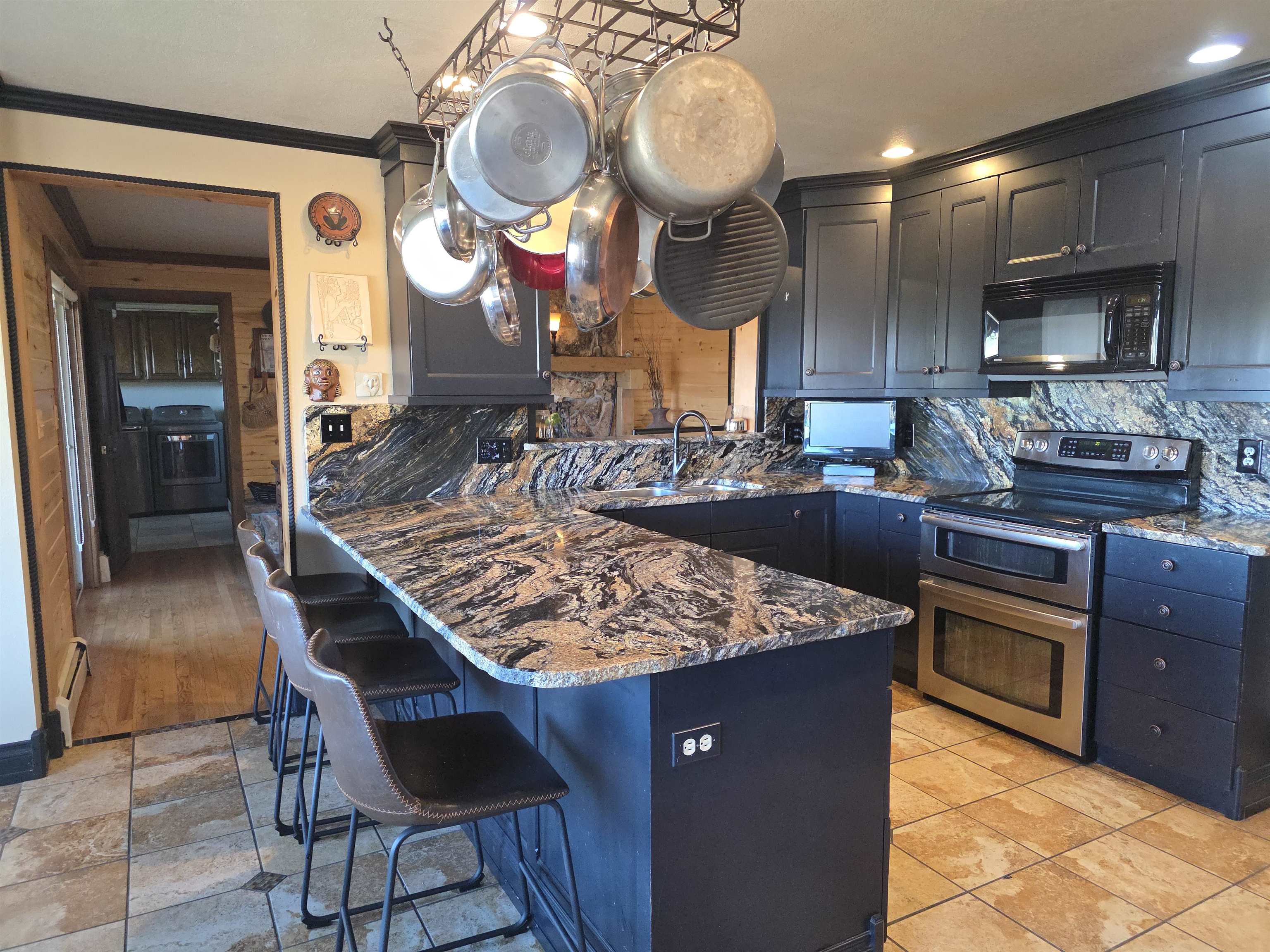 239 West Fallen Rock Road Grand Junction, CO 81507 - Photo 16 of 41 a kitchen with stainless steel appliances granite countertop a stove a sink and a refrigerator
