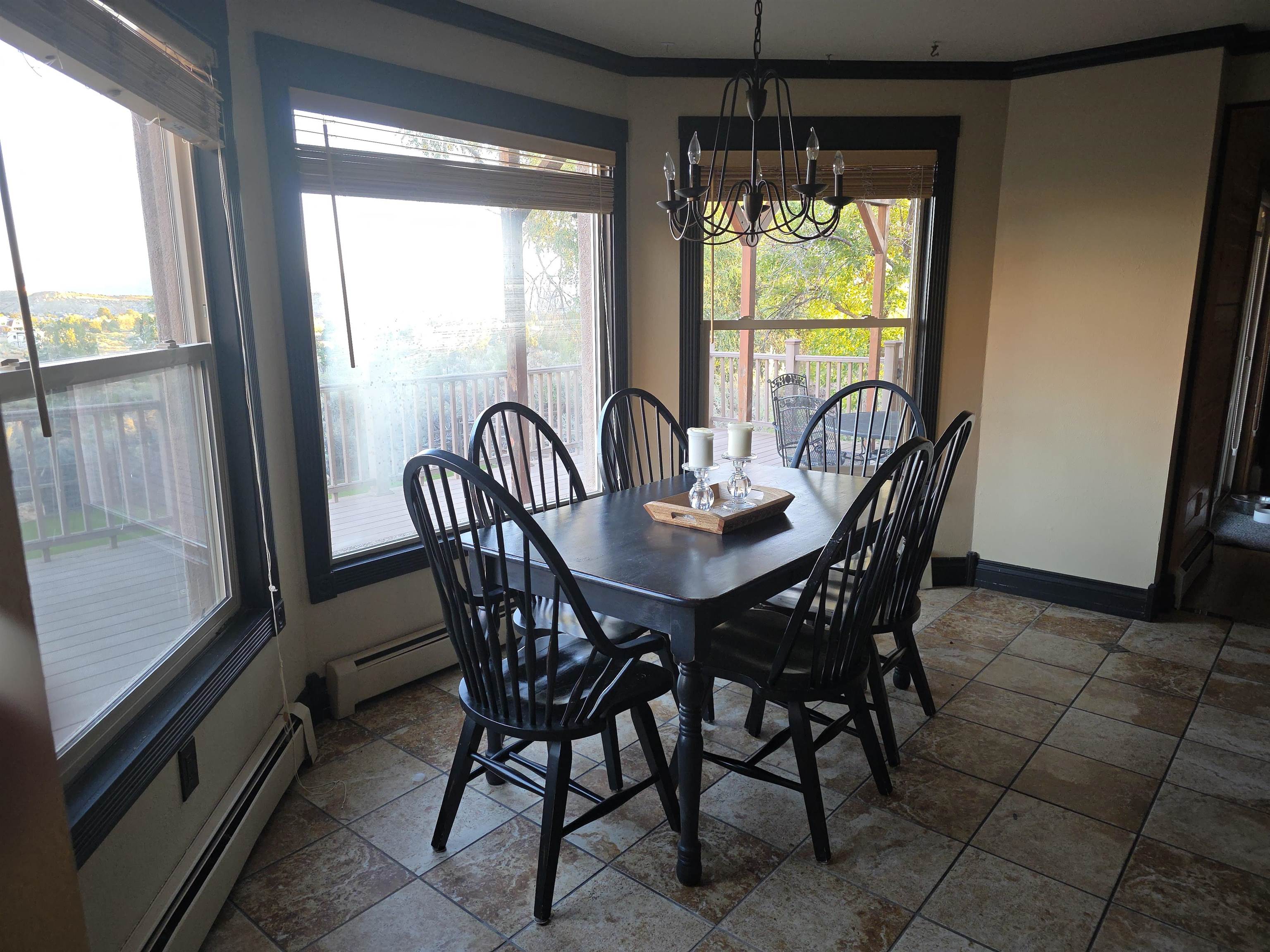 239 West Fallen Rock Road Grand Junction, CO 81507 - Photo 18 of 41 a dining room with furniture a chandelier and wooden floor