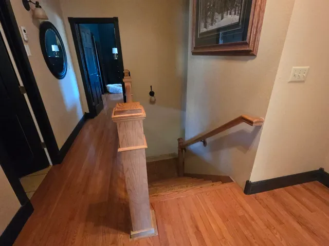 a bedroom with a bed and a flat tv screen on dresser