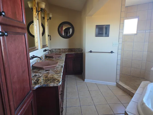 a bedroom with a bed and a flat tv screen on a dresser