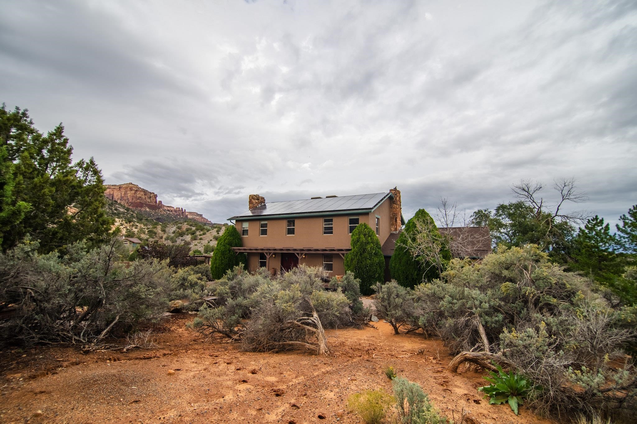 239 West Fallen Rock Road Grand Junction, CO 81507 - Photo 3 of 41 a backyard of a house with a yard and garage