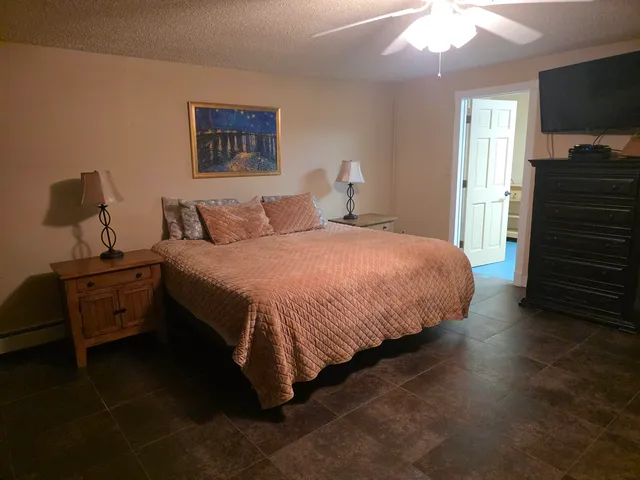 a bathroom with a toilet sink vanity and granite