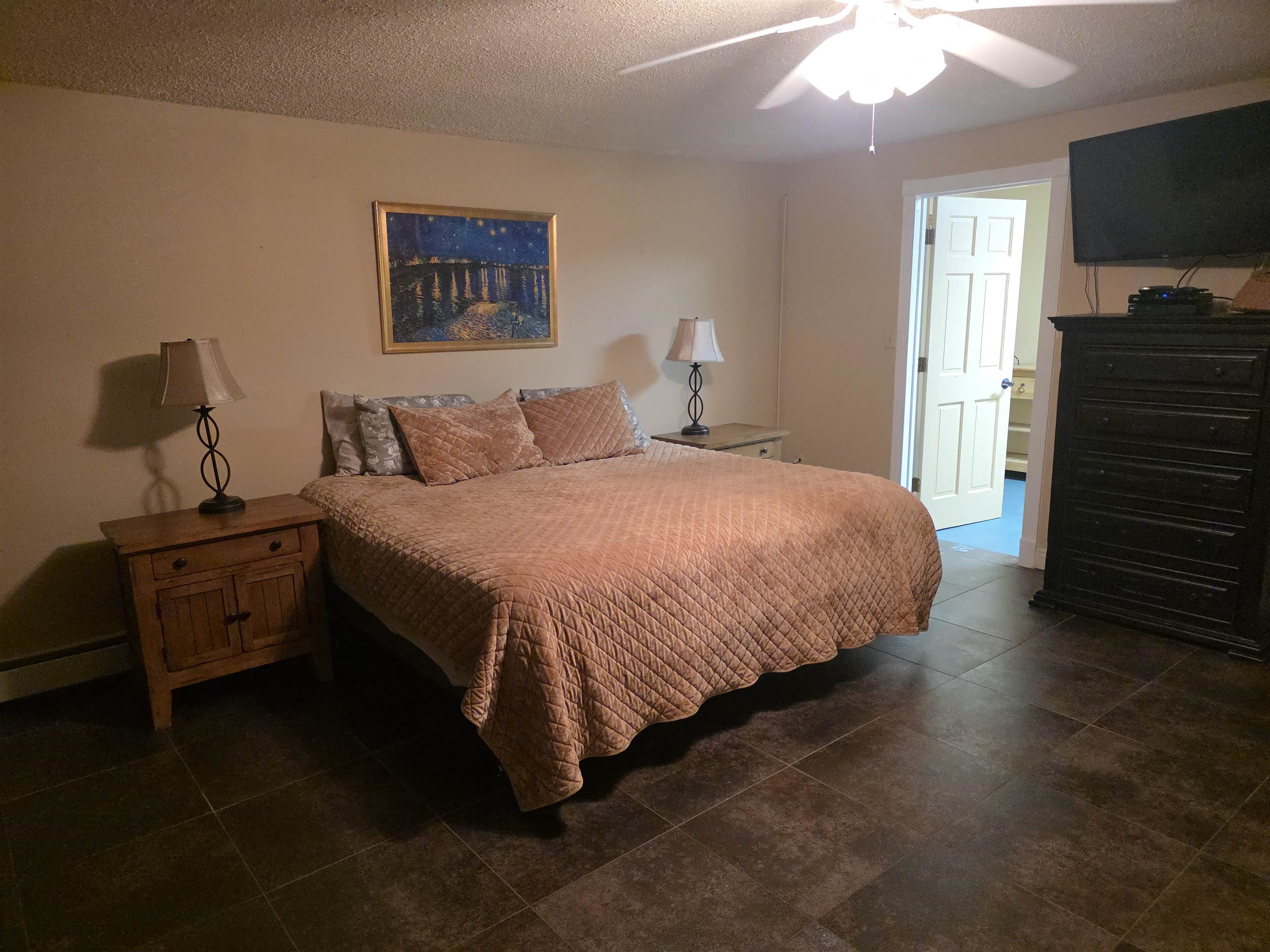 239 West Fallen Rock Road Grand Junction, CO 81507 - Photo 31 of 41 a bedroom with a bed and a flat tv screen on a dresser