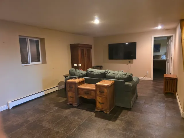 a living room with furniture and a flat screen tv