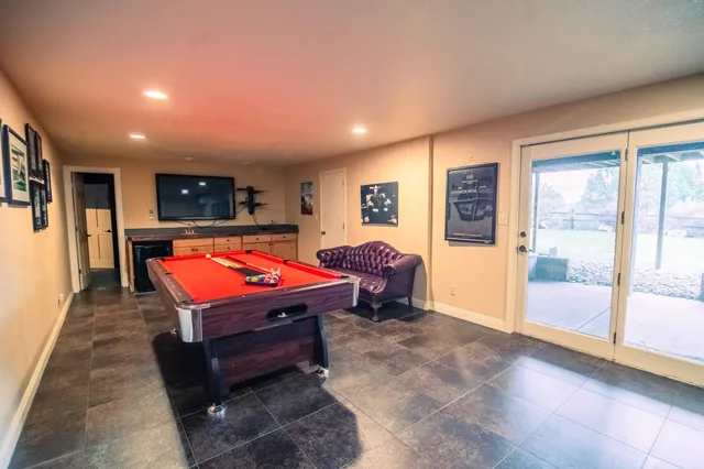 a room with pool table and flat screen tv