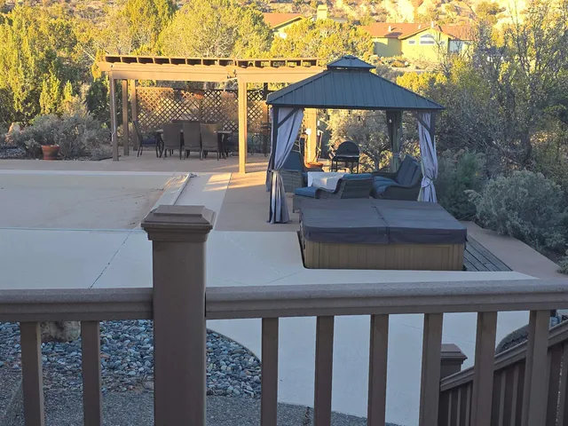 a balcony with wooden floor table and chairs