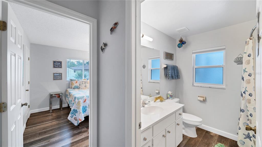 5219 Inverness Drive Sarasota, FL 34243 - Photo 11 of 32 a bathroom with a sink toilet and shower