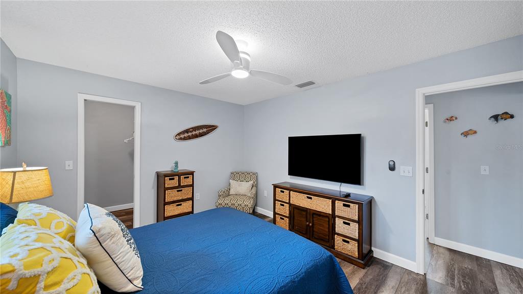 5219 Inverness Drive Sarasota, FL 34243 - Photo 13 of 32 a bedroom with a bed and a flat screen tv