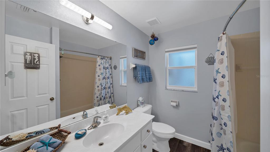 5219 Inverness Drive Sarasota, FL 34243 - Photo 17 of 32 a bathroom with a sink toilet and shower