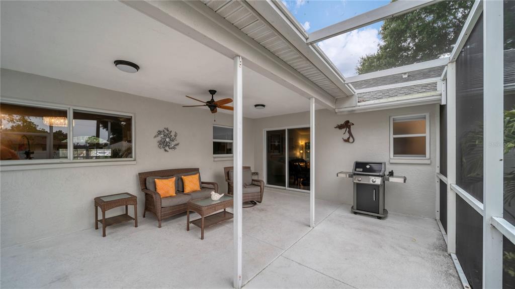 5219 Inverness Drive Sarasota, FL 34243 - Photo 19 of 32 a living room with furniture a rug and white walls