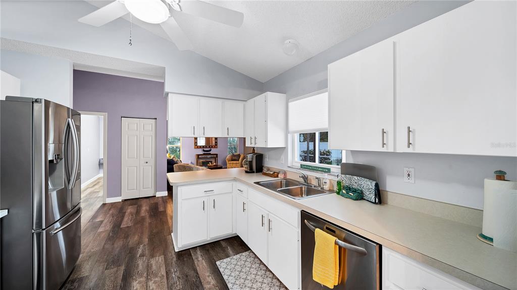 5219 Inverness Drive Sarasota, FL 34243 - Photo 23 of 32 a kitchen with a sink a refrigerator and cabinets