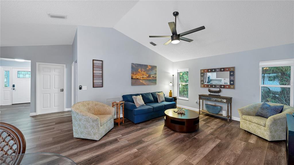 5219 Inverness Drive Sarasota, FL 34243 - Photo 25 of 32 a living room with furniture and a wooden floor