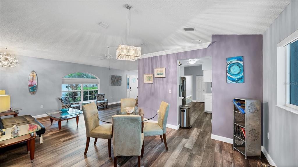 5219 Inverness Drive Sarasota, FL 34243 - Photo 26 of 32 a view of a dining room with furniture and wooden floor